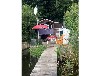 Bootshaus am Malchiner See mit Steg und Boot